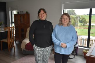 Image of Housing Choice Tasmania tenants Lisa and Lauree standing inside a living room