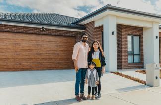 Jay and his family outside their new home
